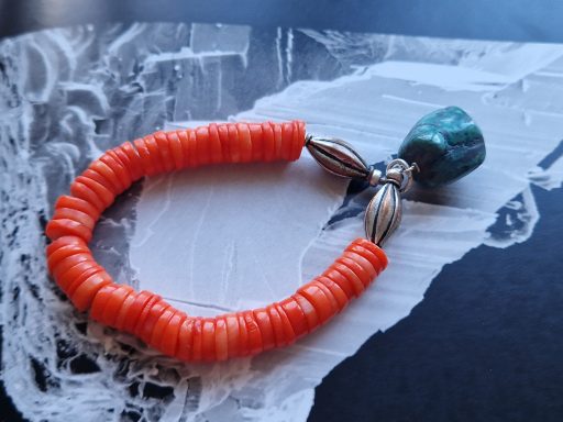 bracelet of orange coral discs with turquoise drop £120